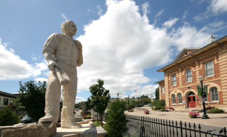 A statue of a man in front of an opera house